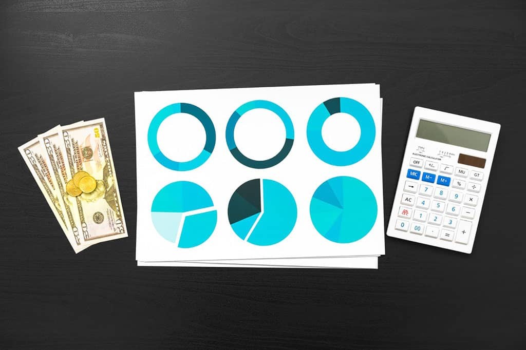 top-view-of-table-with-financial-papers-and-calculators
