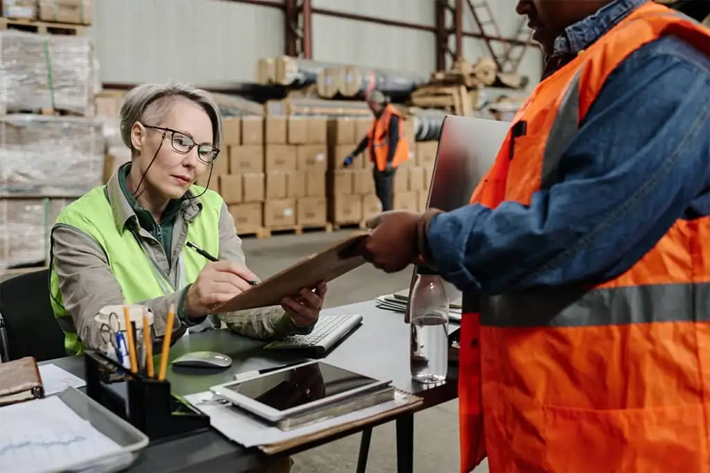 manager-signing-delivery-documents-in-warehouse