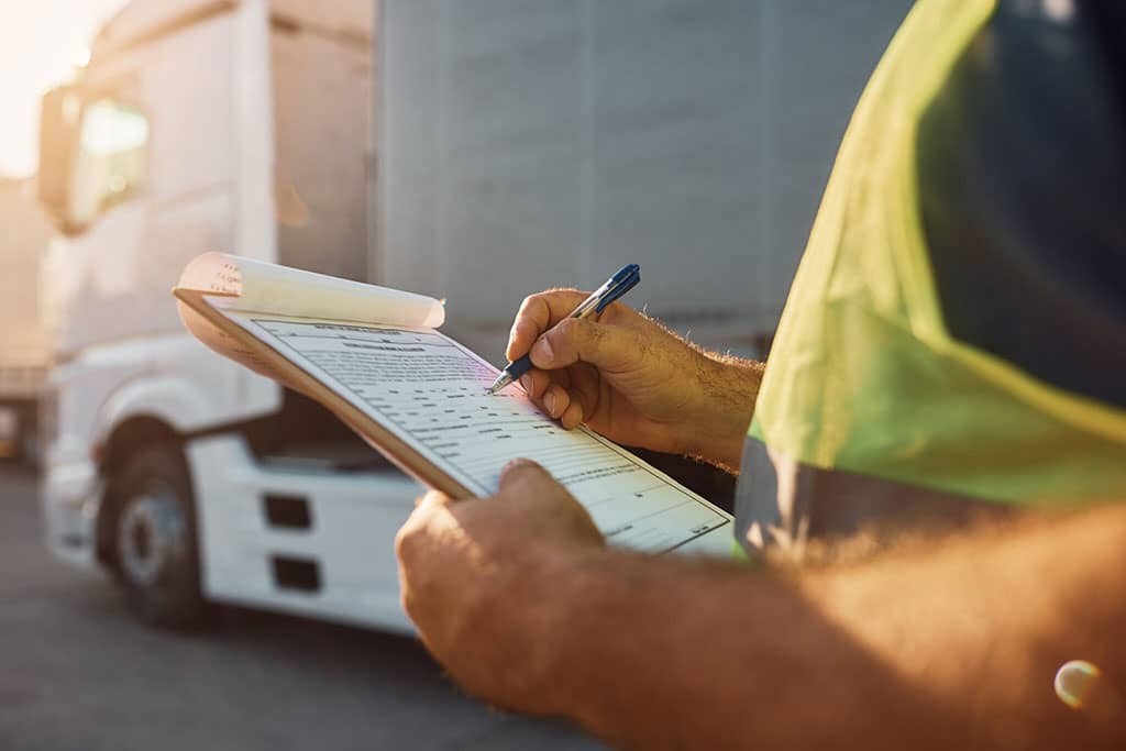 close-up-of-trucking-dispatcher-going-through-checklist-2048x1365-1