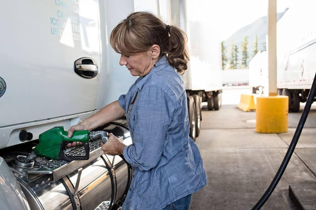 caucasian-woman-truck-driver-filling-truck-with-diesel-2048x1365-1