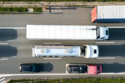 A drone photograph of ig freight trucks on a highway with motion blur effect